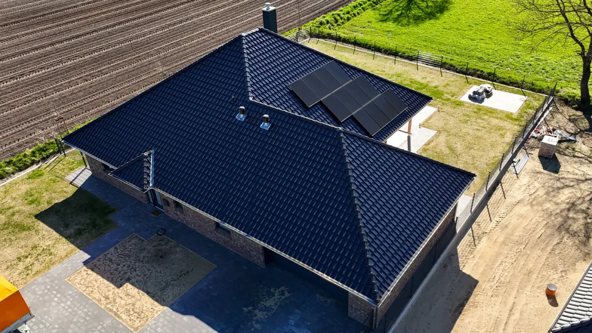 Fertiggestelltes Wohnhaus mit Photovoltaik-Anlage und dunkler Dacheindeckung — Holzrahmenbau-Referenz der Zimmerei Der Holzprofi